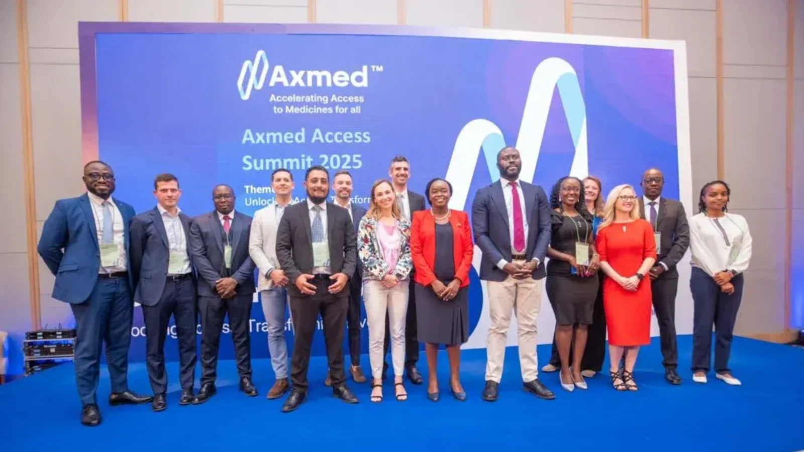Speakers and the Axmed team on stage at the Axmed Access Summit 2025 in Nairobi, in front of the summit backdrop